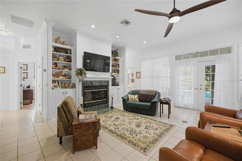 700 Southwest 89th Terrace Ocala, FL 34481 - Photo 19 of 94 a living room with furniture a flat screen tv and a fireplace