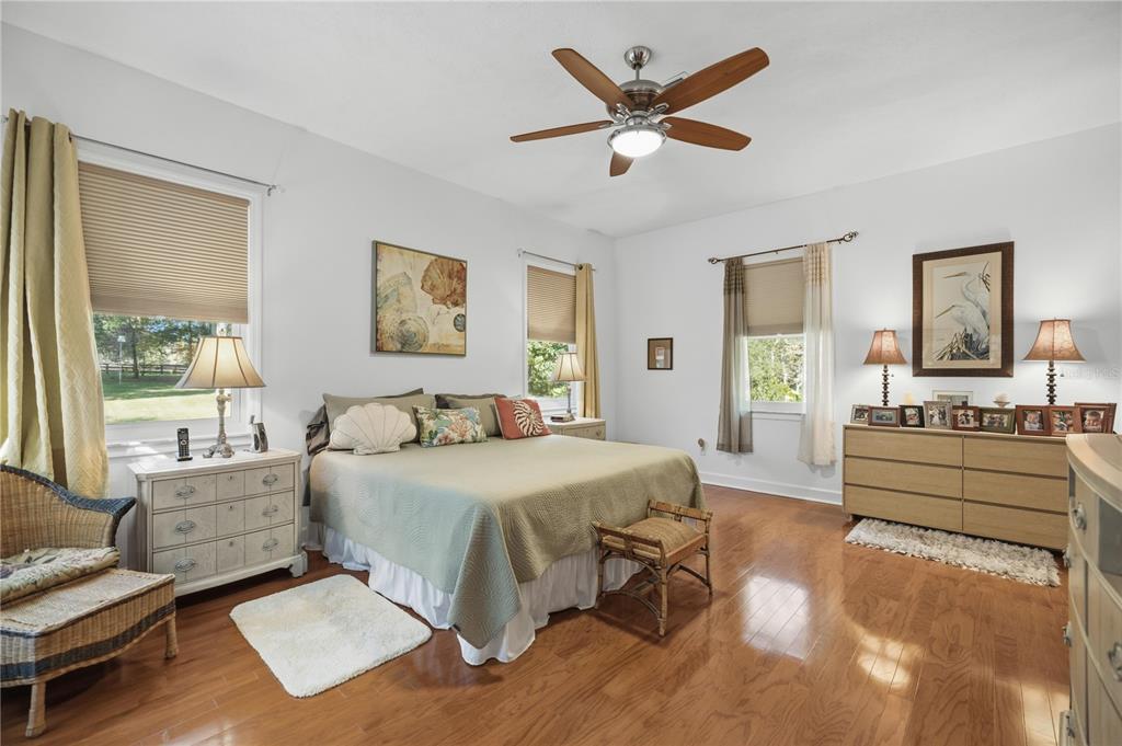 700 Southwest 89th Terrace Ocala, FL 34481 - Photo 30 of 94 a spacious bedroom with a bed a couch and a large window