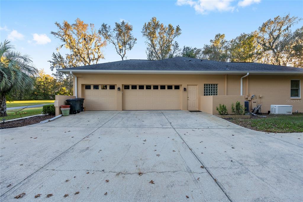700 Southwest 89th Terrace Ocala, FL 34481 - Photo 56 of 94 a front view of a house with a yard and garage