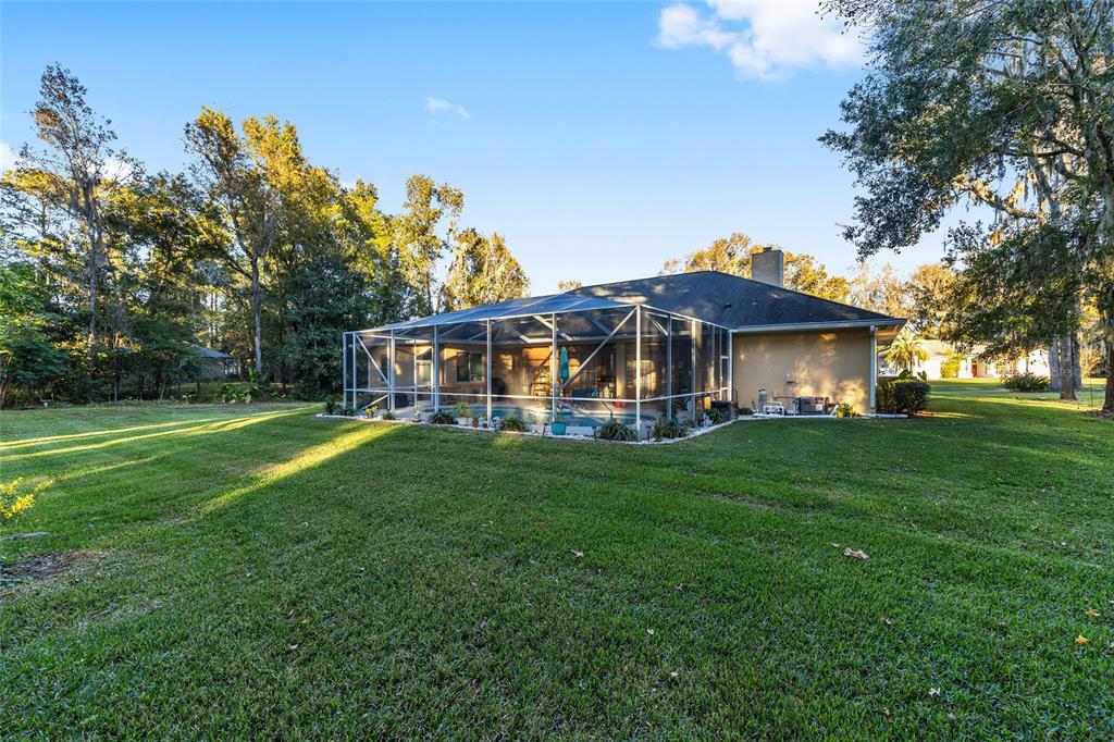 700 Southwest 89th Terrace Ocala, FL 34481 - Photo 65 of 94 a view of a yard with a house in the background