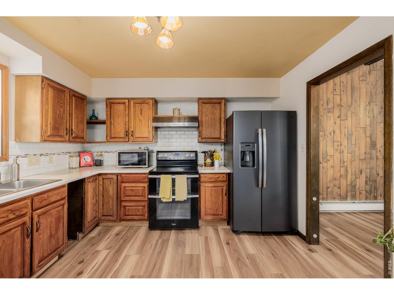 37 High View Lane Boulder, CO 80302 - Photo 16 of 50 a kitchen with stainless steel appliances granite countertop a refrigerator a sink dishwasher and wooden cabinets with wooden floor