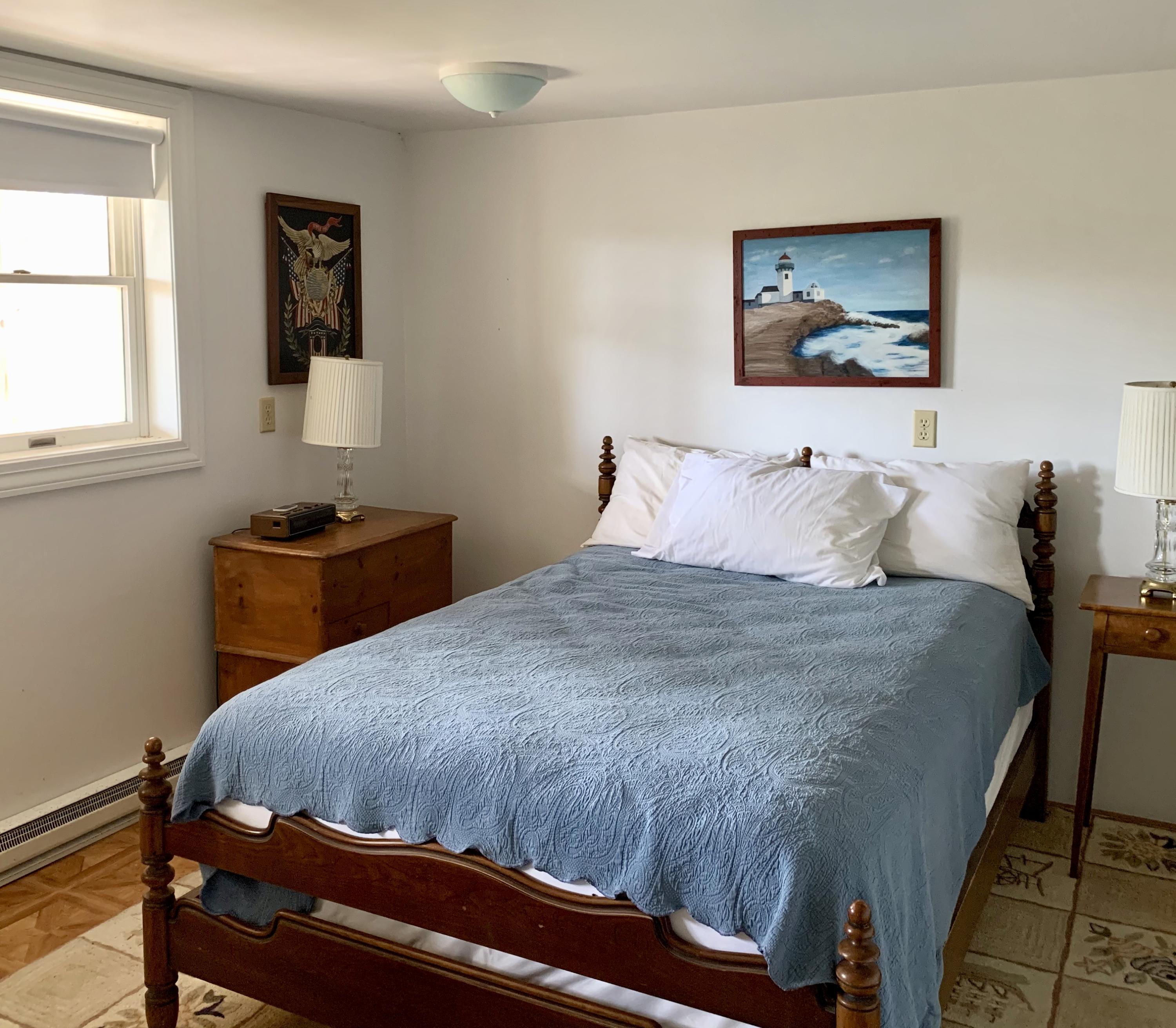 265 Bay Road Harwich, MA 02645 - Photo 26 of 38 a bedroom with a bed and wooden floor