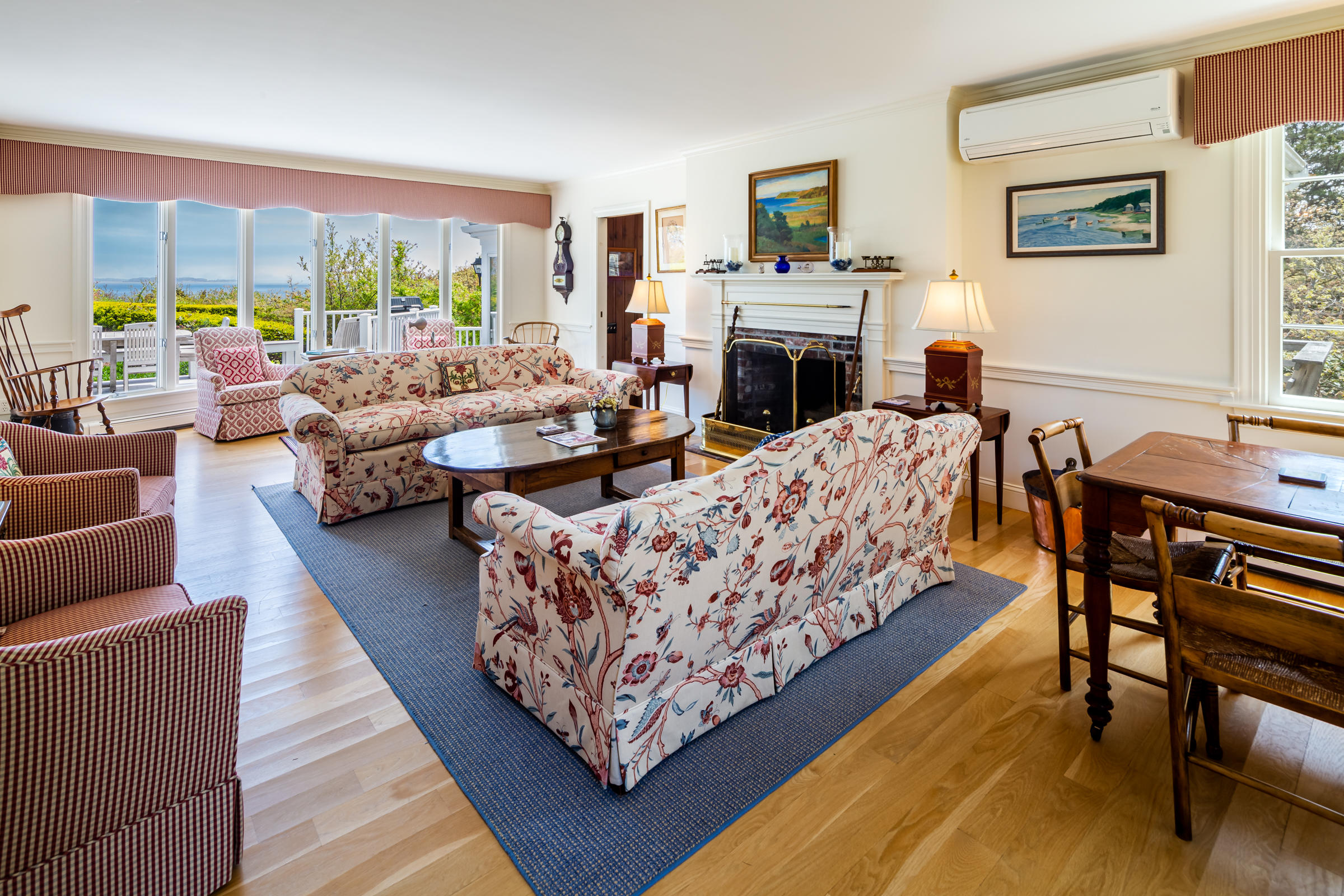 265 Bay Road Harwich, MA 02645 - Photo 5 of 38 a living room with furniture large window and a fireplace