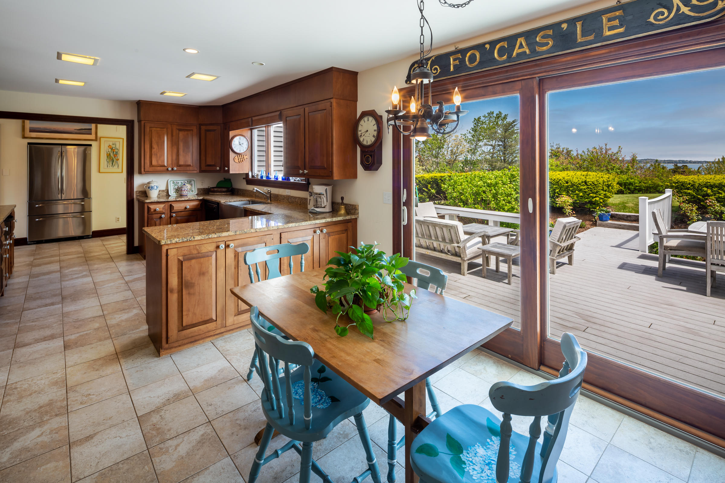 265 Bay Road Harwich, MA 02645 - Photo 10 of 38 a kitchen with stainless steel appliances granite countertop a stove a refrigerator a kitchen island and chairs in it