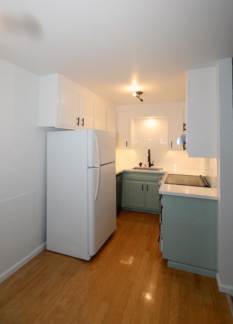 1124 Hollywood Avenue, Unit 3 Oakland, CA 94602 - Photo 2 of 11 a room with a sink cabinets and a refrigerator