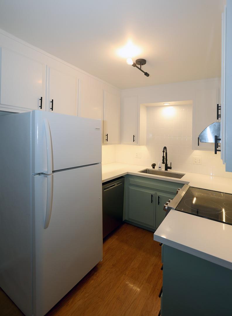 1124 Hollywood Avenue, Unit 3 Oakland, CA 94602 - Photo 4 of 11 a kitchen with a refrigerator and a sink