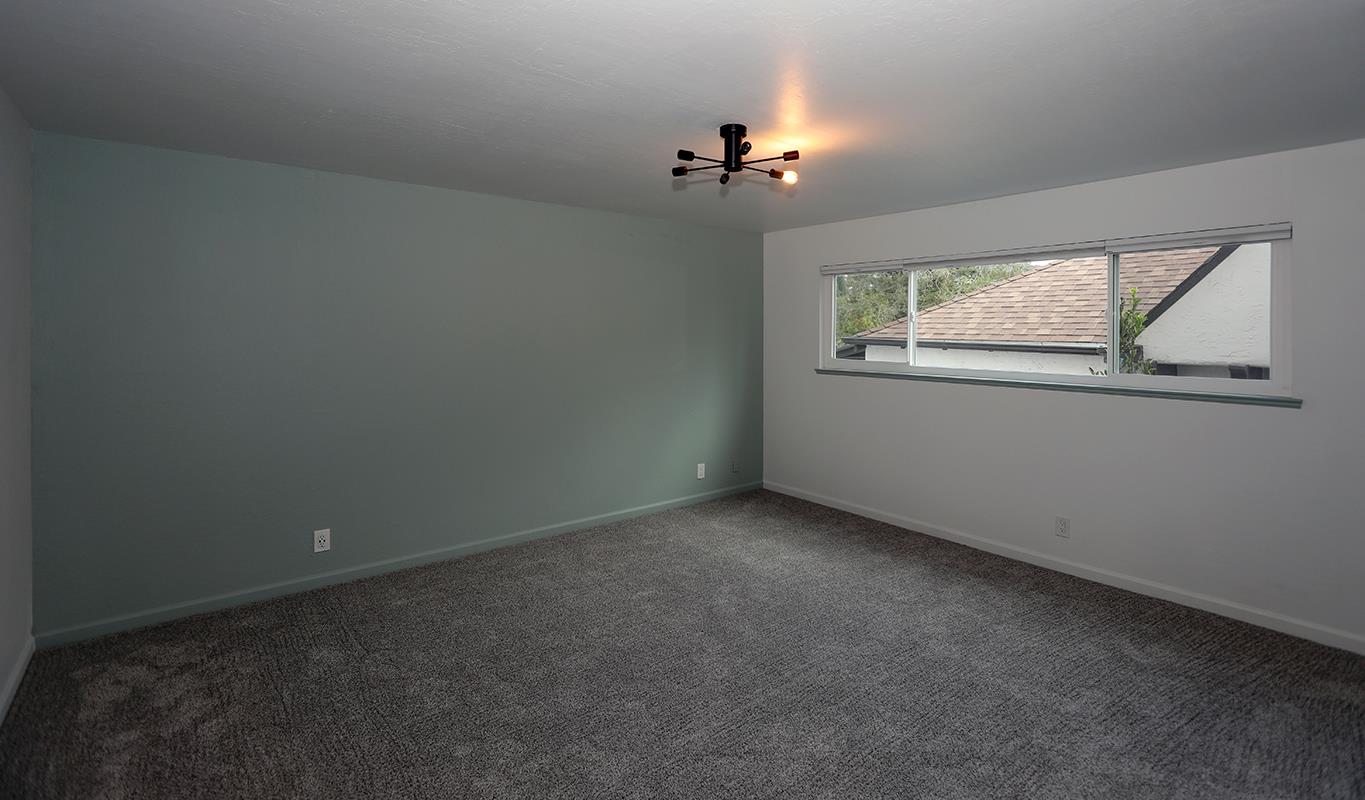 1124 Hollywood Avenue, Unit 3 Oakland, CA 94602 - Photo 5 of 11 an empty room with windows and fan