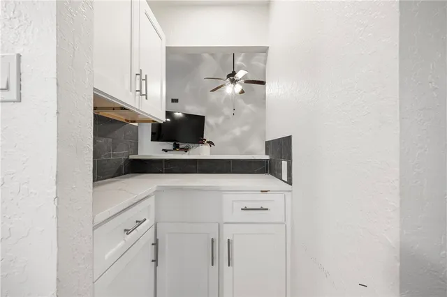 a kitchen with stainless steel appliances white cabinets and a sink