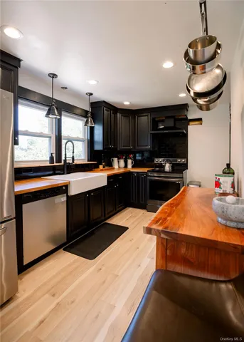 a kitchen with stainless steel appliances kitchen island granite countertop a sink and stove top oven