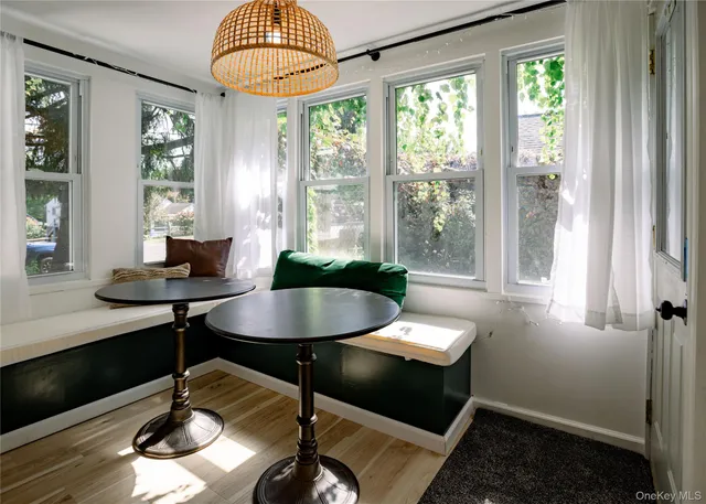 a view of a dining room with furniture wooden floor and a chandelier
