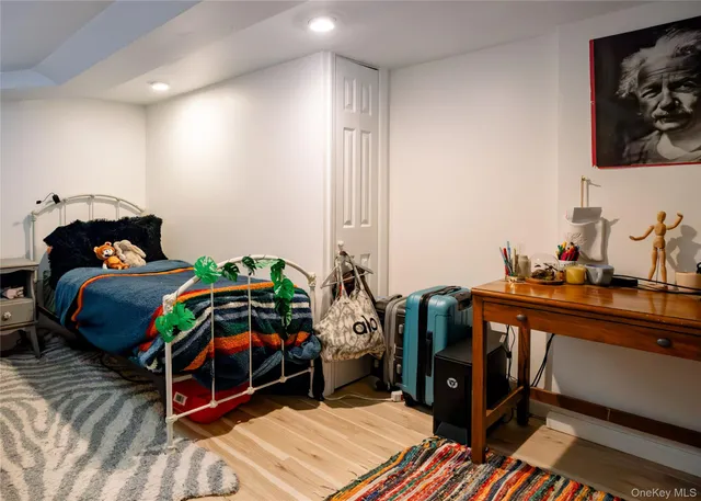 a bedroom with a bed and a tv