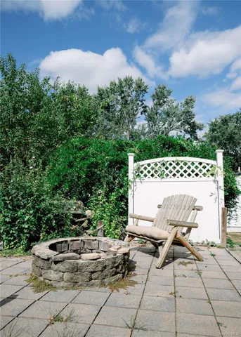 a view of a chairs and table in the backyard