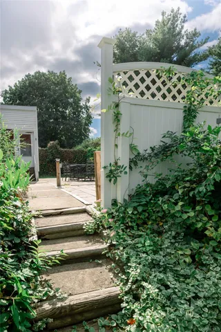 a view of a house with a yard and potted plants