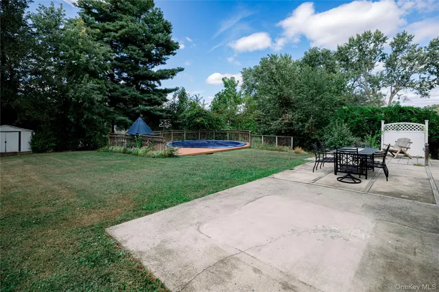 a view of a backyard with sitting area