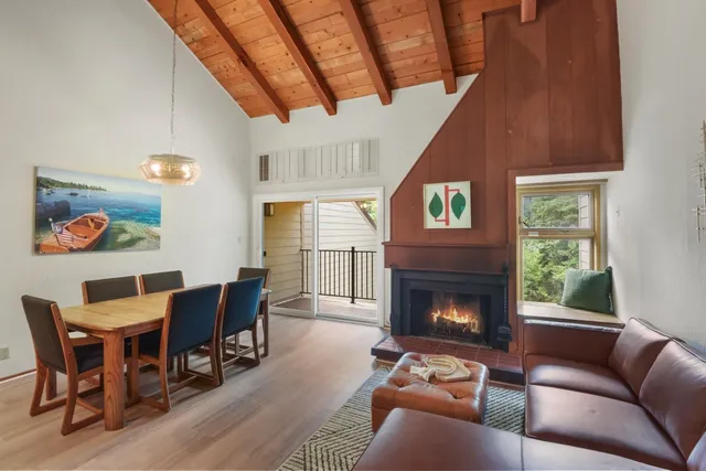 a living room with furniture a fireplace and a window