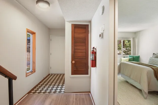 a bedroom with a bed and wooden floor