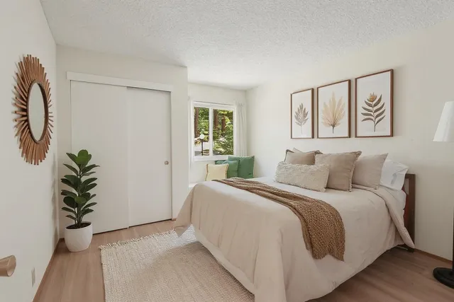 a bed room with a bed and a potted plant