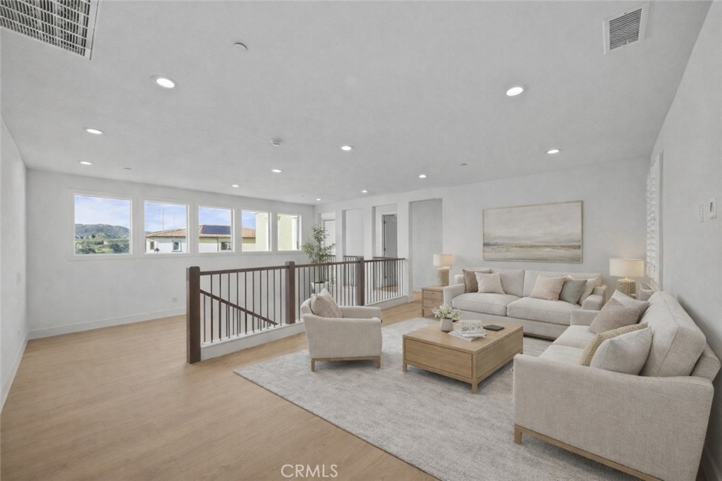 20638 Deer Grass Court Porter Ranch, CA 91326 - Photo 9 of 50 a living room with furniture and a ceiling fan