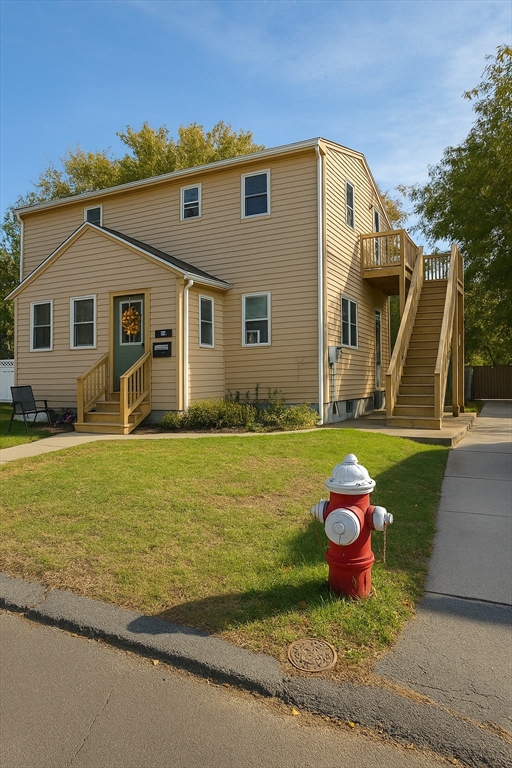 1042 Sassaquin Avenue, Unit 2 New Bedford, MA 02745 - Photo 2 of 13 a front view of a house with yard