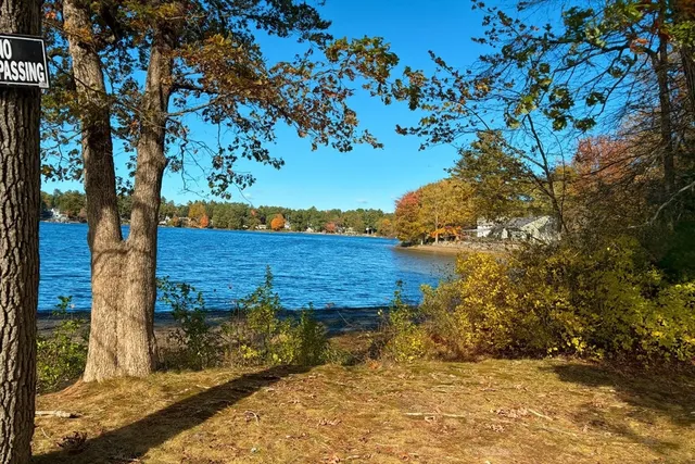 a view of a yard with wooden fence