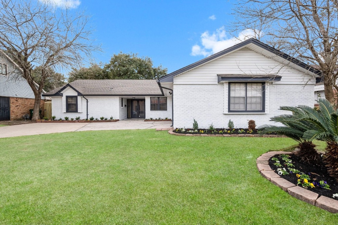 322 East Edgebrook Drive Houston, TX 77034 - Photo 1 of 38 a front view of a house with a garden and yard