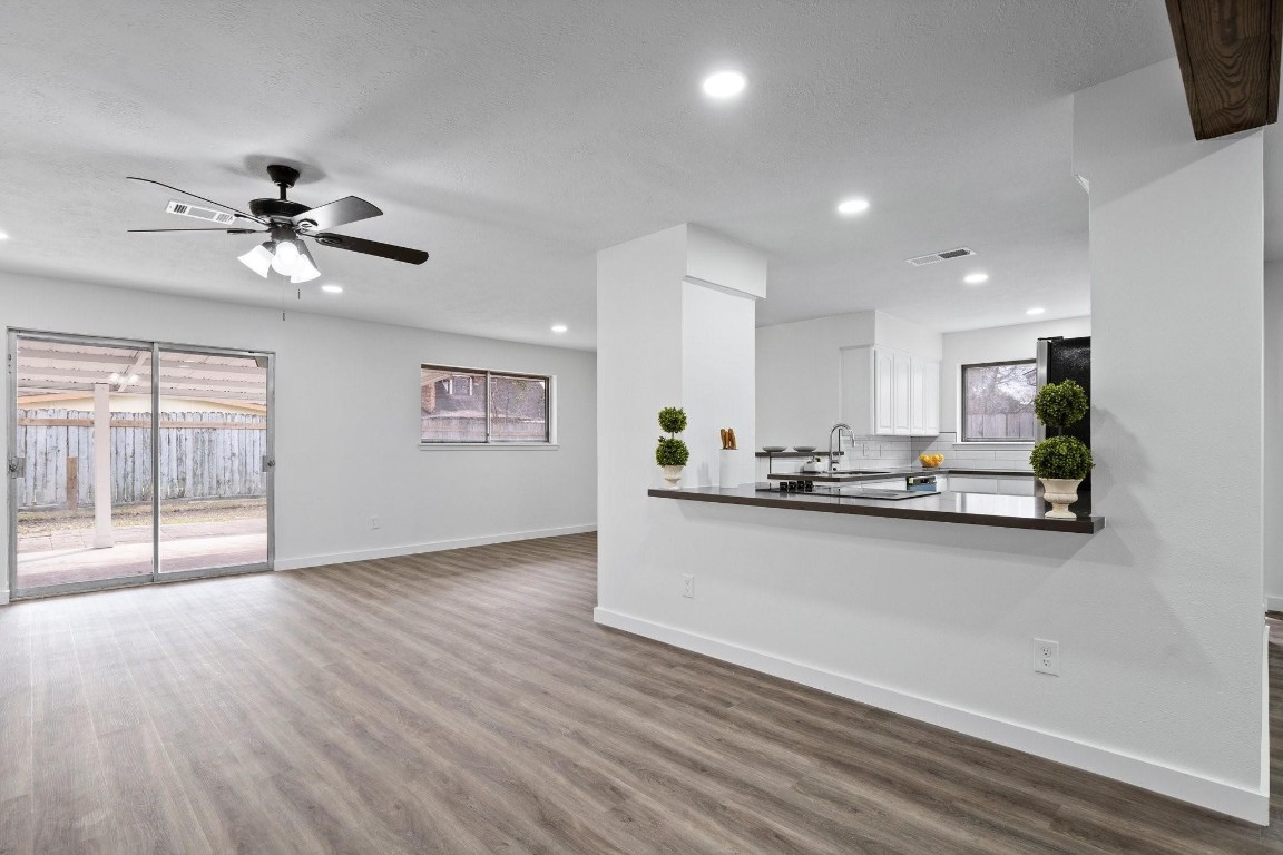 322 East Edgebrook Drive Houston, TX 77034 - Photo 12 of 38 a view of a kitchen with wooden floor and a ceiling fan
