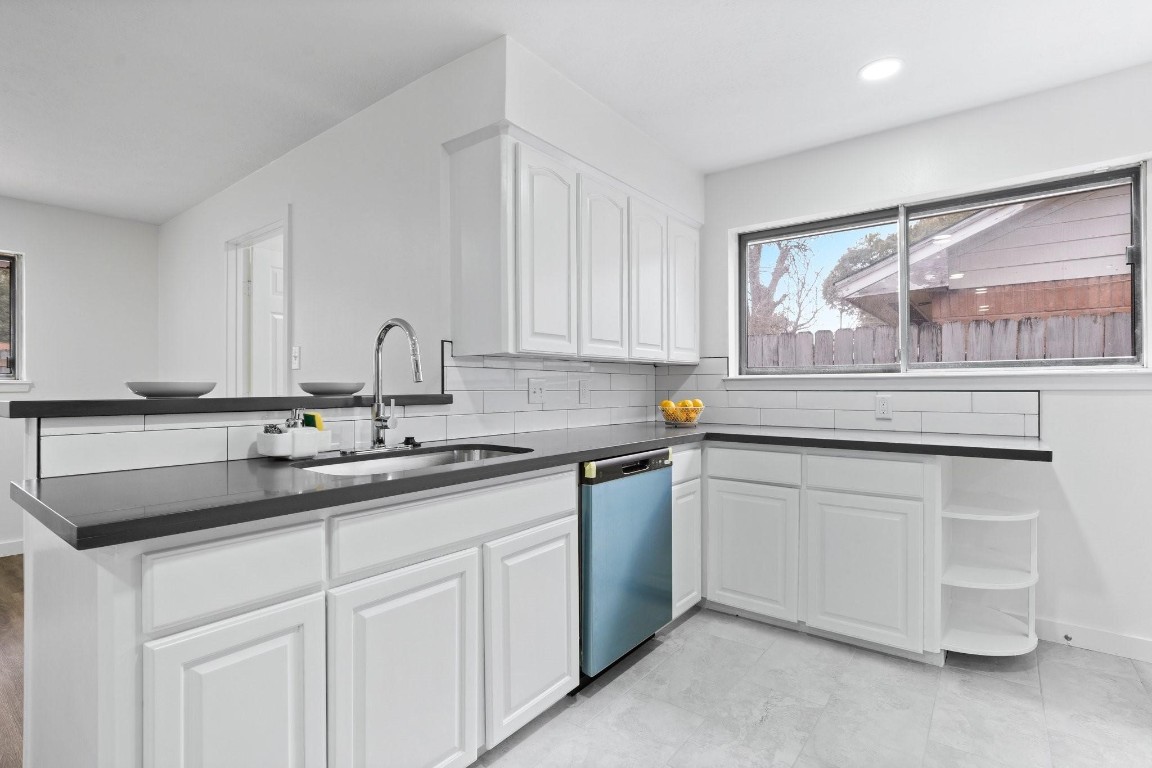 322 East Edgebrook Drive Houston, TX 77034 - Photo 13 of 38 a kitchen with a sink and cabinets