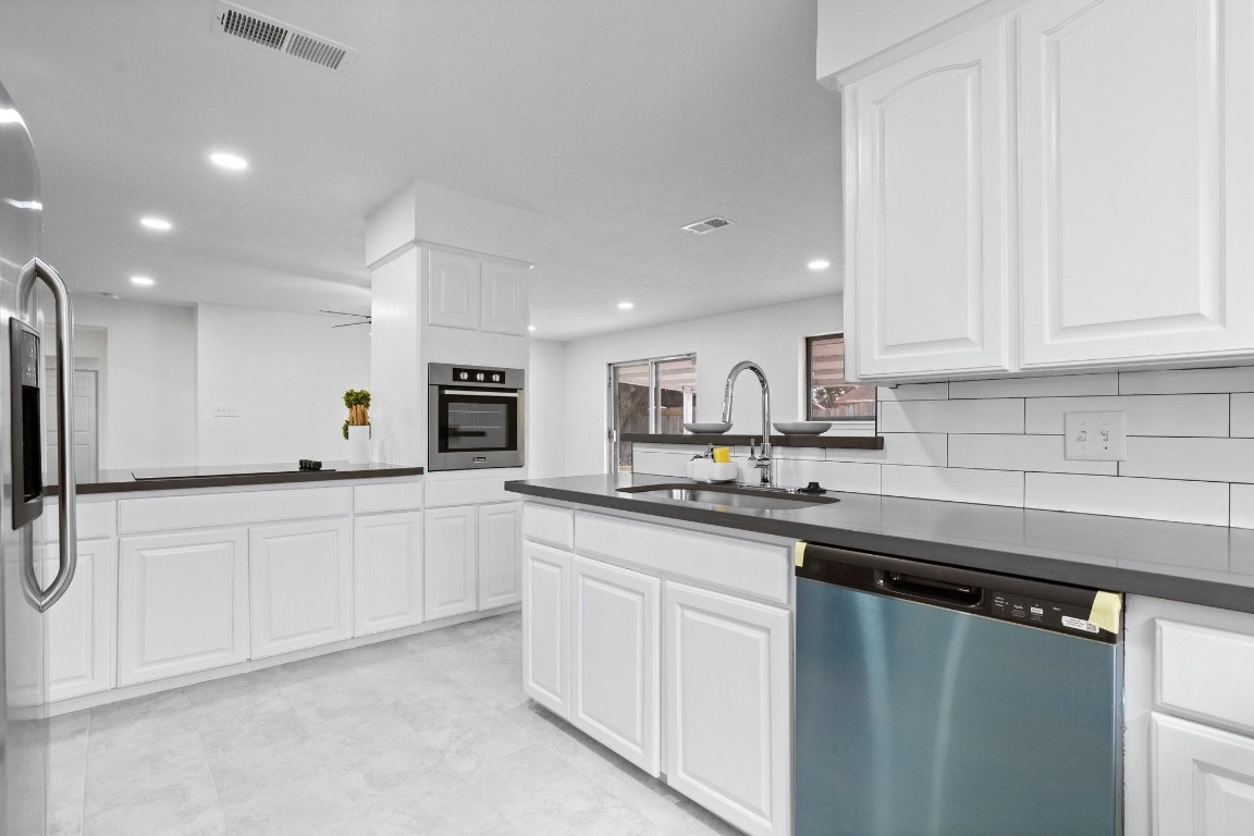 322 East Edgebrook Drive Houston, TX 77034 - Photo 14 of 38 a kitchen with stainless steel appliances granite countertop a sink and cabinets