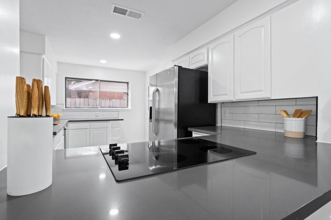 322 East Edgebrook Drive Houston, TX 77034 - Photo 16 of 38 a kitchen with stainless steel appliances a refrigerator and a sink