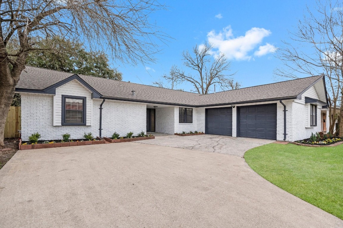 322 East Edgebrook Drive Houston, TX 77034 - Photo 2 of 38 a view of a house with a yard and large tree
