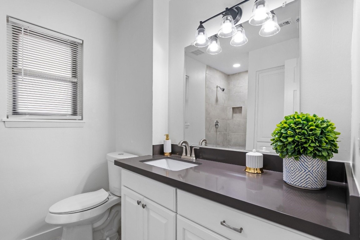 322 East Edgebrook Drive Houston, TX 77034 - Photo 23 of 38 a bathroom with a granite countertop sink a toilet and a mirror
