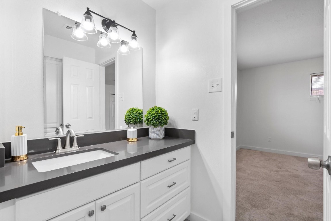 322 East Edgebrook Drive Houston, TX 77034 - Photo 24 of 38 a bathroom with a granite countertop sink and a mirror
