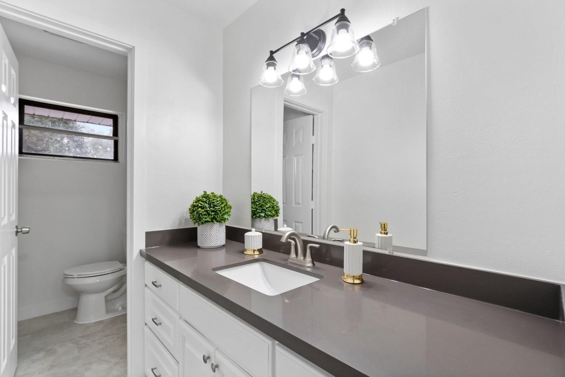 322 East Edgebrook Drive Houston, TX 77034 - Photo 32 of 38 a bathroom with a sink a toilet and a mirror