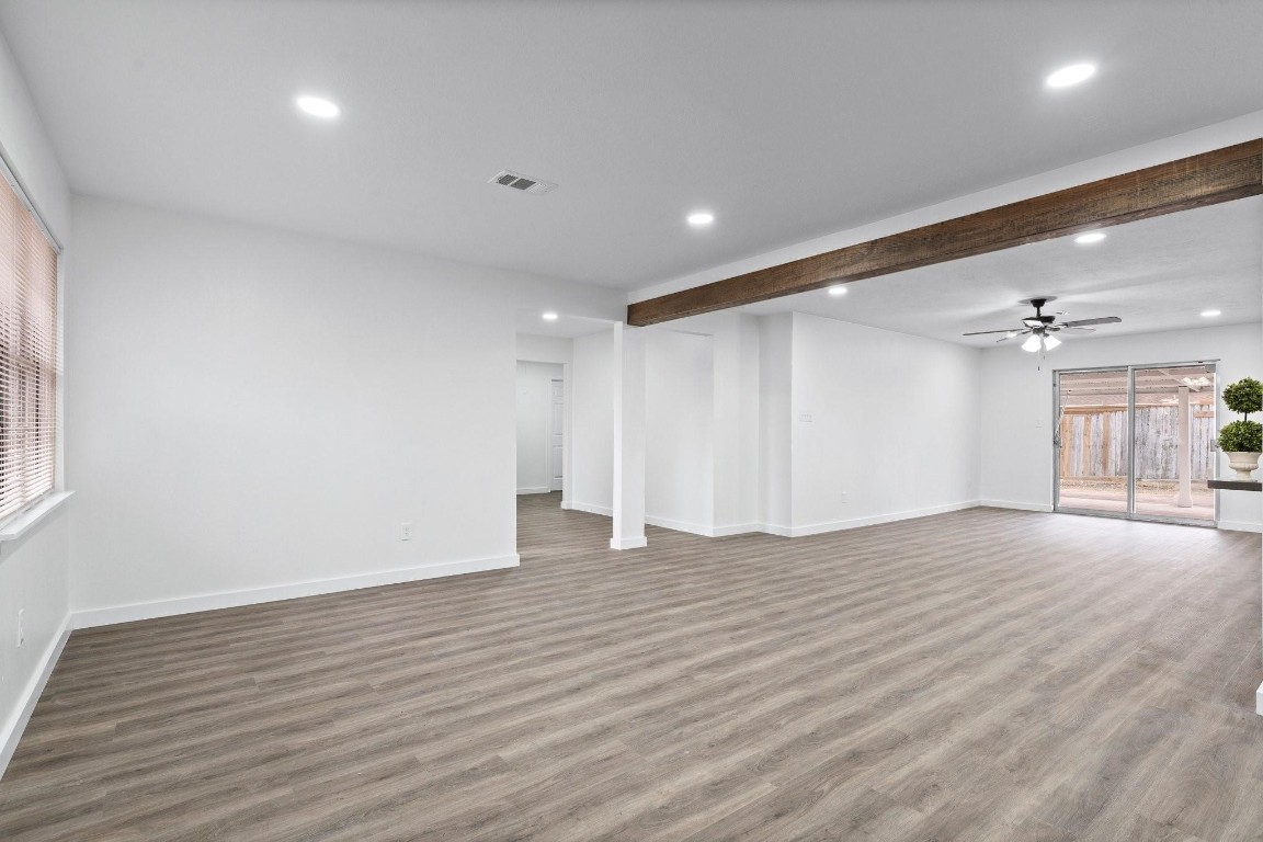 322 East Edgebrook Drive Houston, TX 77034 - Photo 4 of 38 a view of an empty room with wooden floor and a window