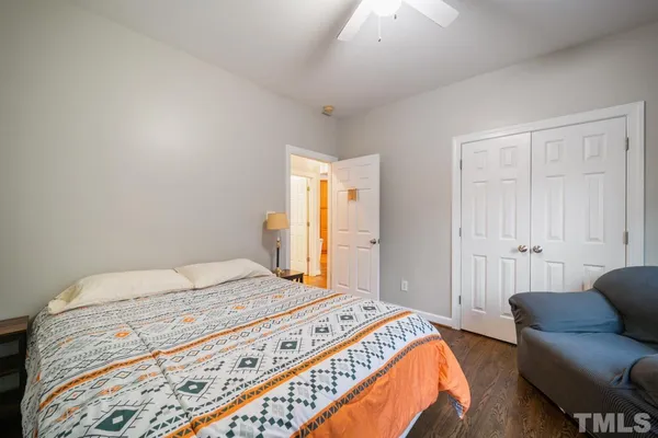 a bedroom with a bed couch and a window
