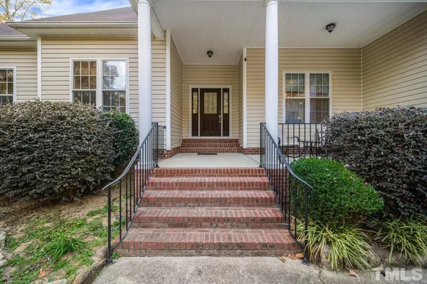 a front view of a house with a garden