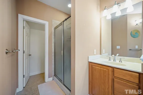 a bathroom with a sink a toilet and shower curtain