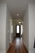 a view of a hallway view with wooden floor and staircase