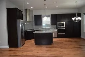 a kitchen with a refrigerator and a sink