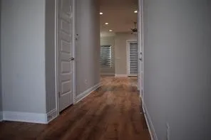 a view of hallway with wooden floor