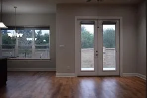 a view of wooden floor and window in a room