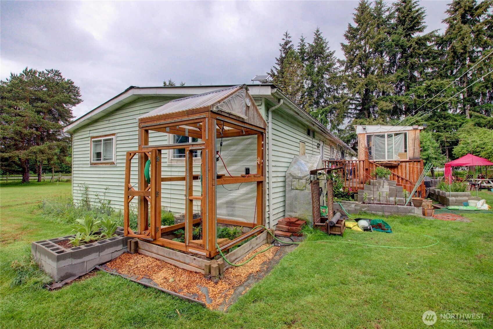 7185 Old Highway 99 North Road Burlington, WA 98233 - Photo 13 of 26 a front view of house with a garden and patio