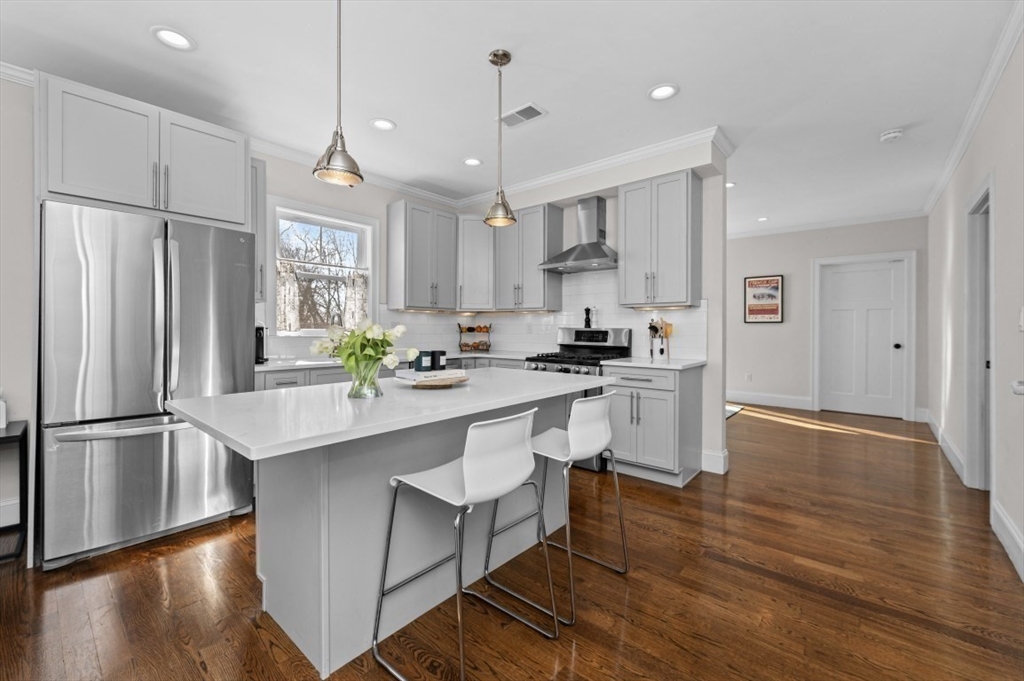 72-74 Manthorne Road, Unit 74 Boston, MA 02132 - Photo 1 of 22 a kitchen with white cabinets and stainless steel appliances