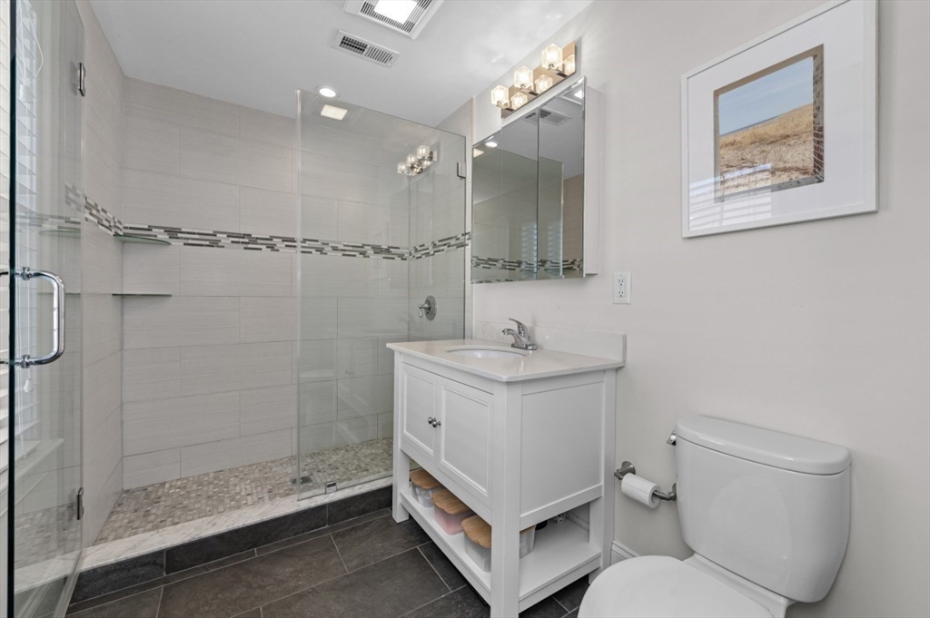 72-74 Manthorne Road, Unit 74 Boston, MA 02132 - Photo 12 of 22 a bathroom with a sink toilet and shower