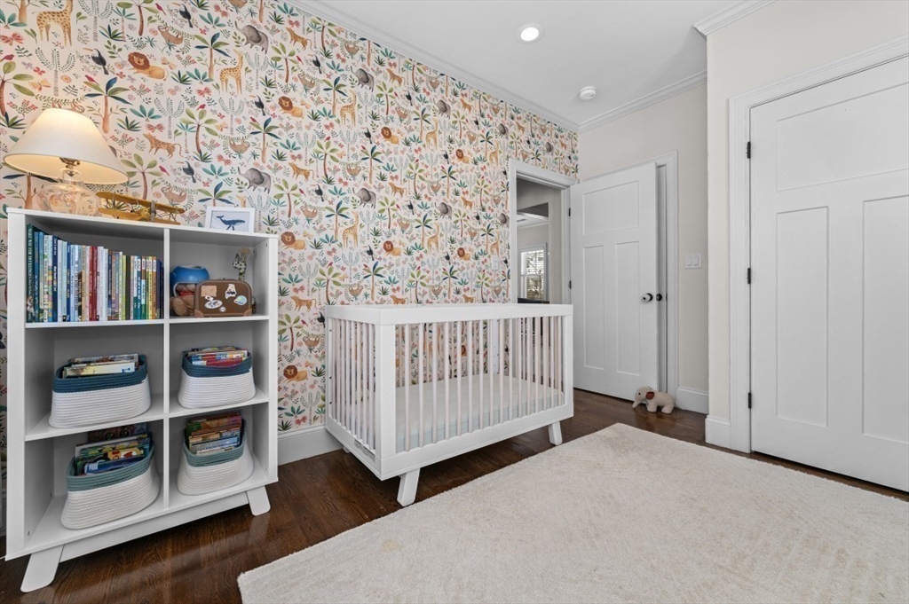 72-74 Manthorne Road, Unit 74 Boston, MA 02132 - Photo 14 of 22 a bedroom with furniture and wooden floor
