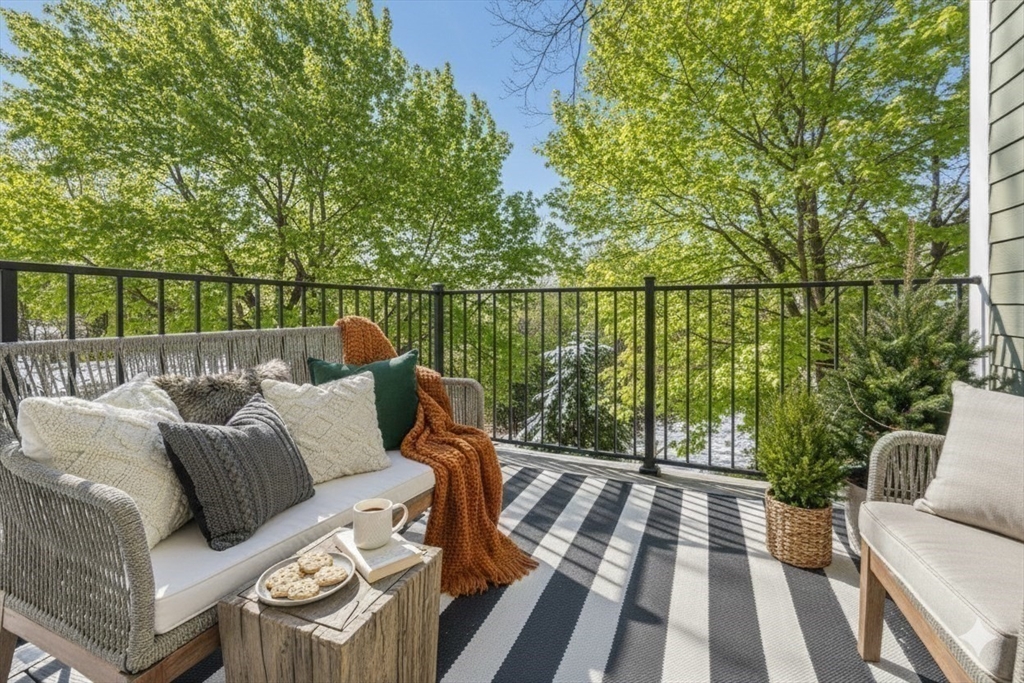 72-74 Manthorne Road, Unit 74 Boston, MA 02132 - Photo 10 of 22 a balcony with wooden floor and outdoor seating