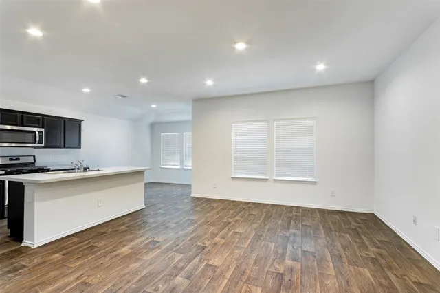 a view of kitchen with wooden floor and electronic appliances