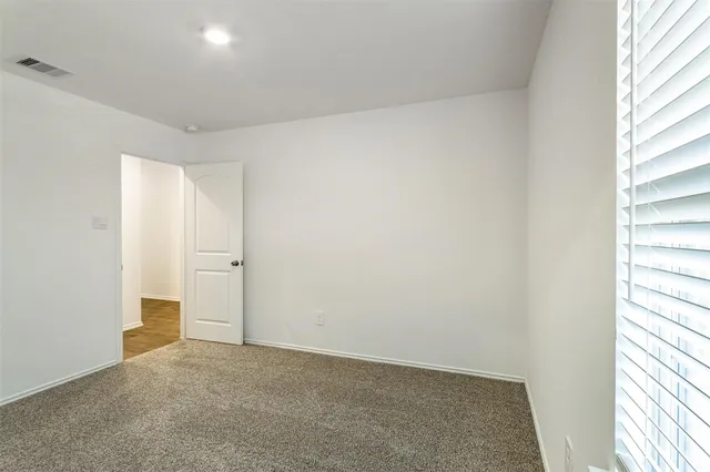 a view of an empty room and a window