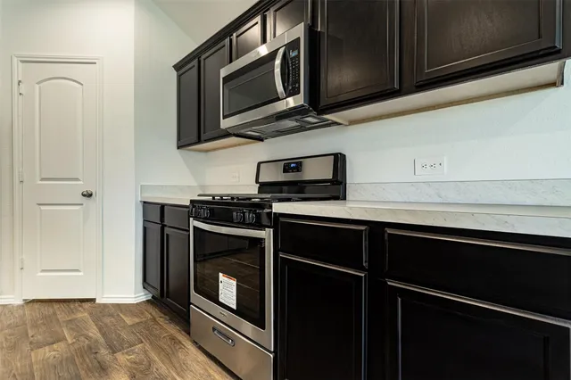 a kitchen with stainless steel appliances and cabinets