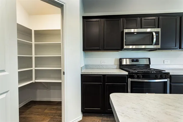 a kitchen with a stove and a microwave